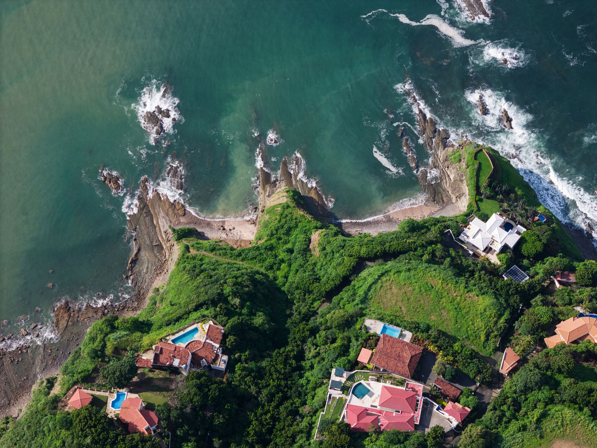 Luxury villas on green tropical waterfront