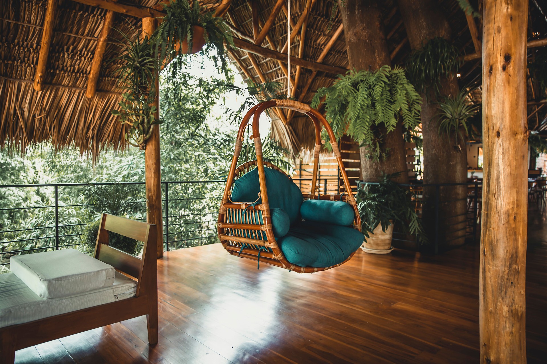 Cozy interior of veranda in boho style with garden furniture